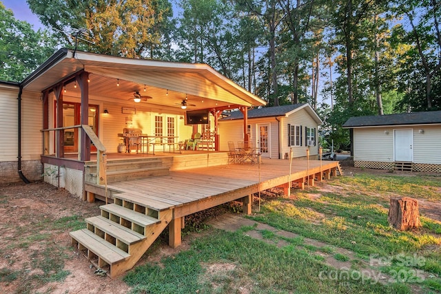 wooden terrace with ceiling fan and a storage unit