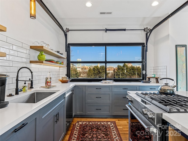 kitchen featuring plenty of natural light, light hardwood / wood-style flooring, sink, and stainless steel appliances