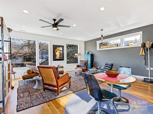 living room featuring ceiling fan and light hardwood / wood-style floors