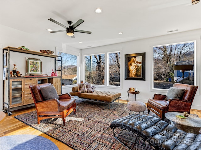 living room with ceiling fan and hardwood / wood-style floors