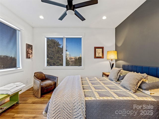 bedroom with hardwood / wood-style floors and ceiling fan