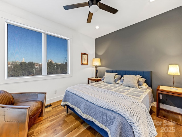 bedroom with ceiling fan and light hardwood / wood-style flooring