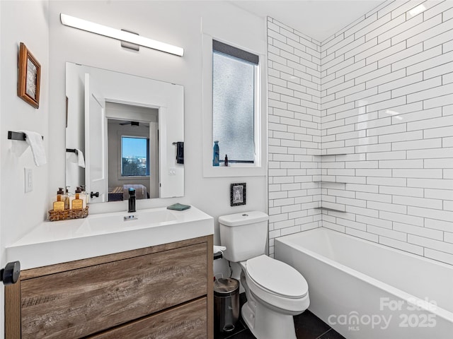 full bathroom featuring tiled shower / bath, vanity, and toilet