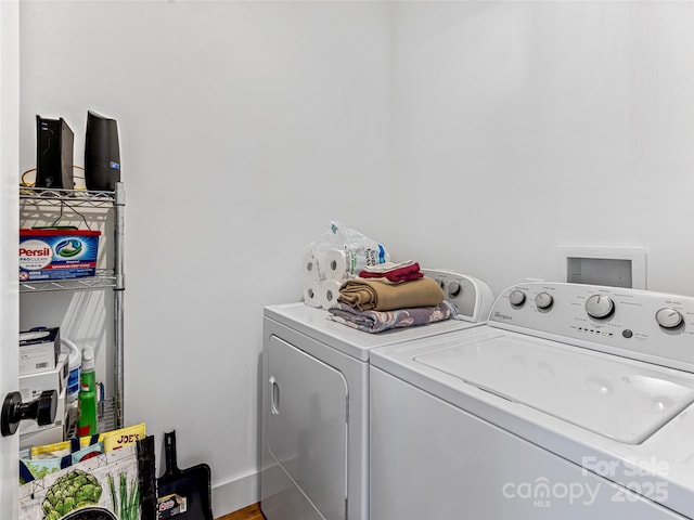 laundry area with hardwood / wood-style flooring and washer and dryer