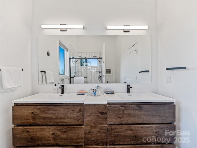 bathroom with vanity and a shower with shower door