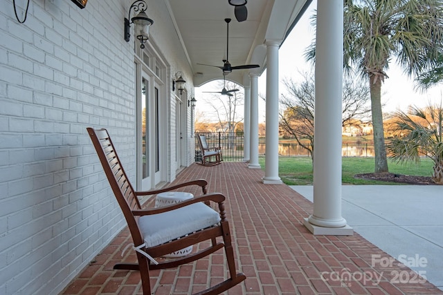 view of patio with ceiling fan and a porch