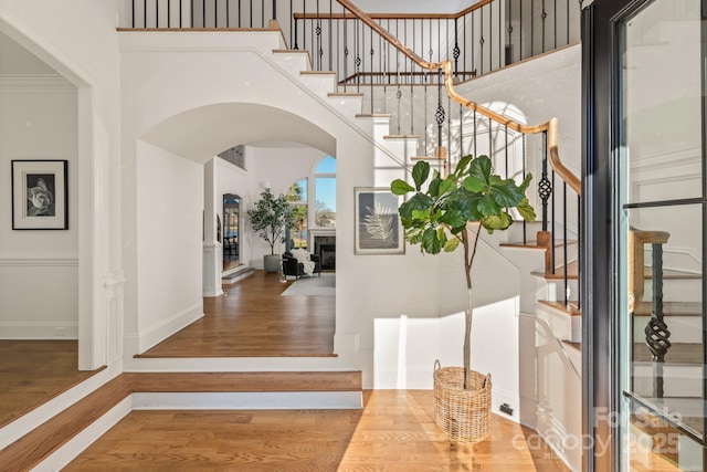 entryway with crown molding and hardwood / wood-style floors