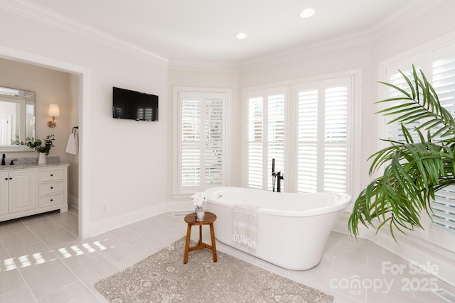 bathroom with a tub, tile patterned floors, vanity, and crown molding