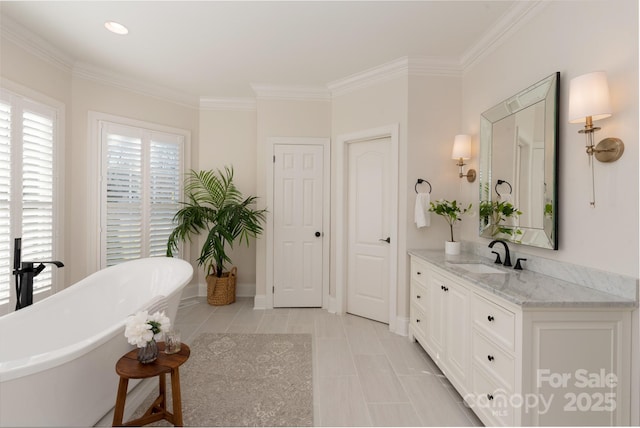 bathroom with a washtub, tile patterned floors, vanity, and ornamental molding