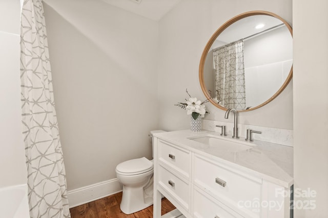 full bathroom with toilet, vanity, wood-type flooring, and shower / tub combo with curtain