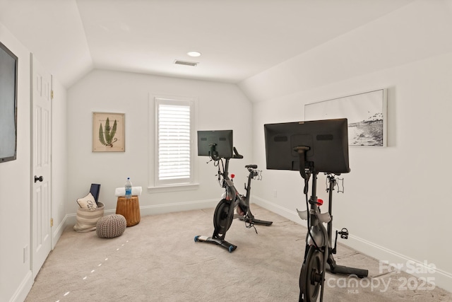 workout area featuring vaulted ceiling and carpet flooring