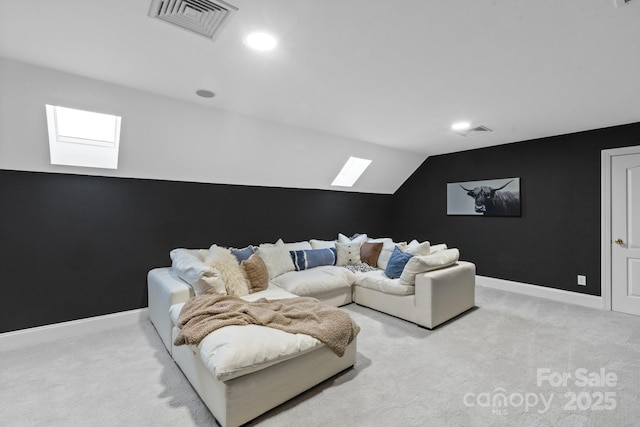 carpeted living room with vaulted ceiling with skylight