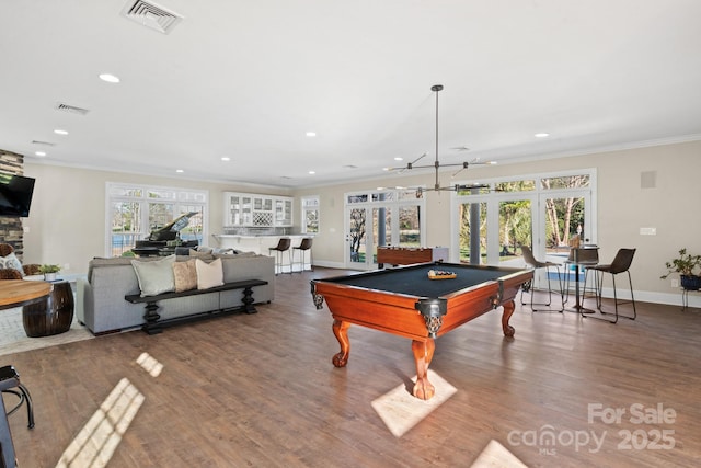 game room with hardwood / wood-style flooring, pool table, ornamental molding, and french doors