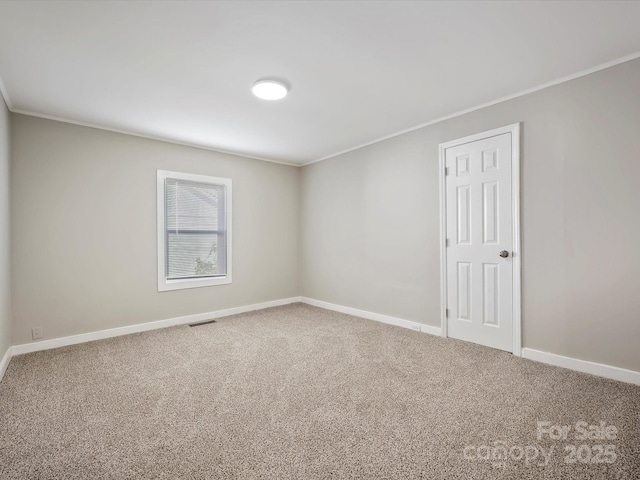 unfurnished room featuring carpet flooring and ornamental molding