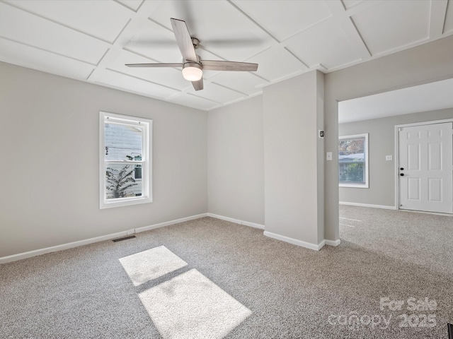 spare room featuring carpet and ceiling fan