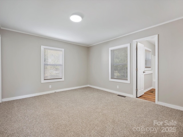 carpeted spare room with ornamental molding