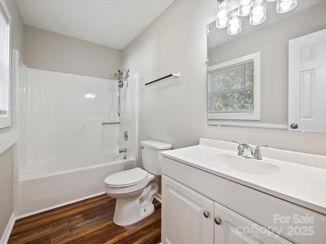 full bathroom featuring wood-type flooring, vanity, toilet, and tub / shower combination