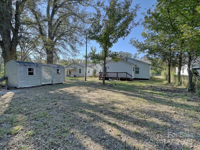 view of yard with a storage unit and a wooden deck