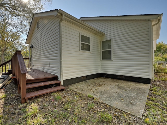 view of property exterior featuring a wooden deck