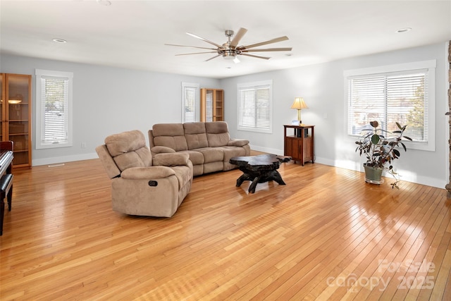 living room with ceiling fan and light wood-type flooring