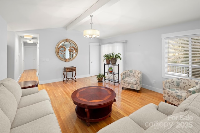 living room featuring wood-type flooring and vaulted ceiling with beams