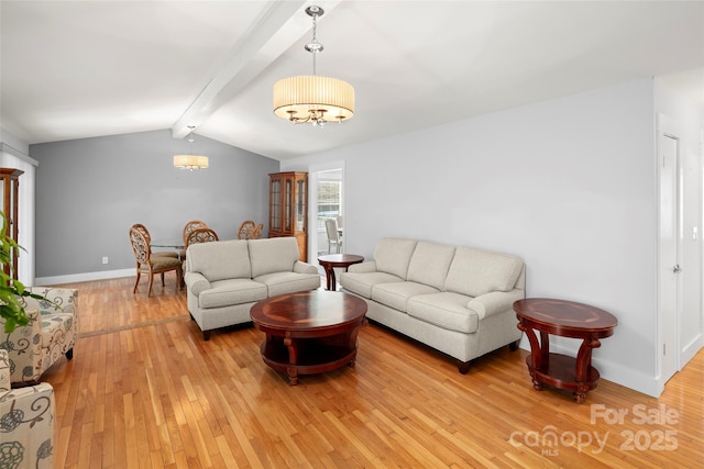 living room featuring vaulted ceiling with beams, light hardwood / wood-style flooring, and a chandelier