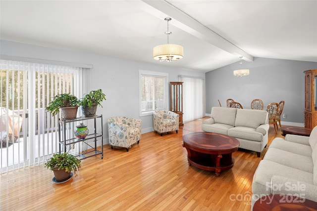 living room featuring vaulted ceiling with beams and wood-type flooring