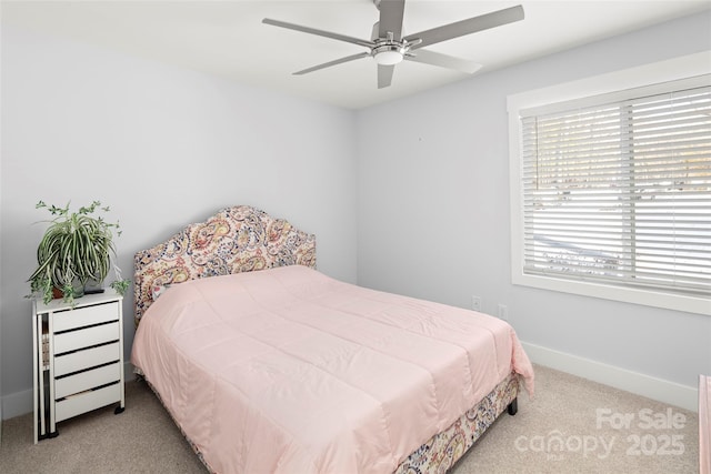 bedroom featuring light colored carpet and ceiling fan