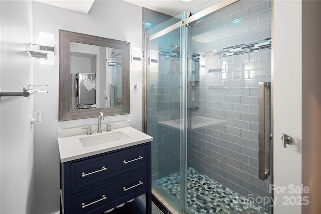 bathroom featuring vanity and a shower with shower door