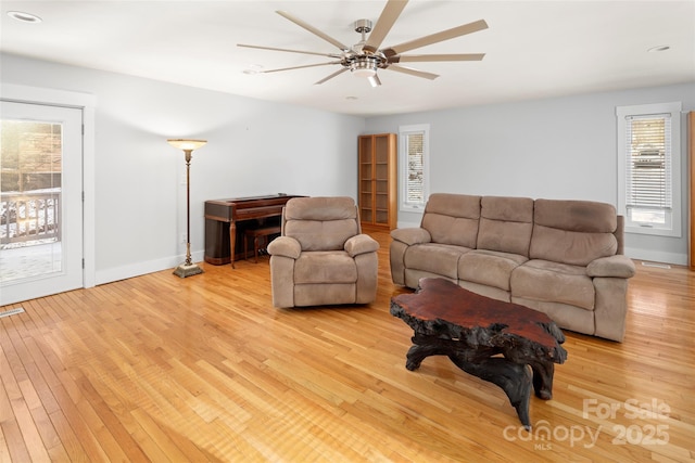 living room featuring ceiling fan and light hardwood / wood-style floors