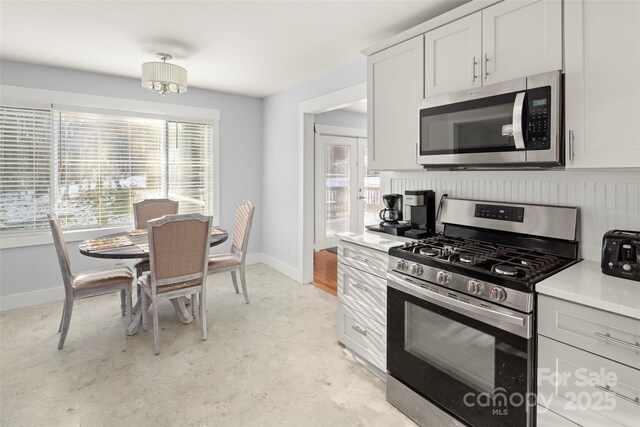 kitchen with appliances with stainless steel finishes and white cabinets