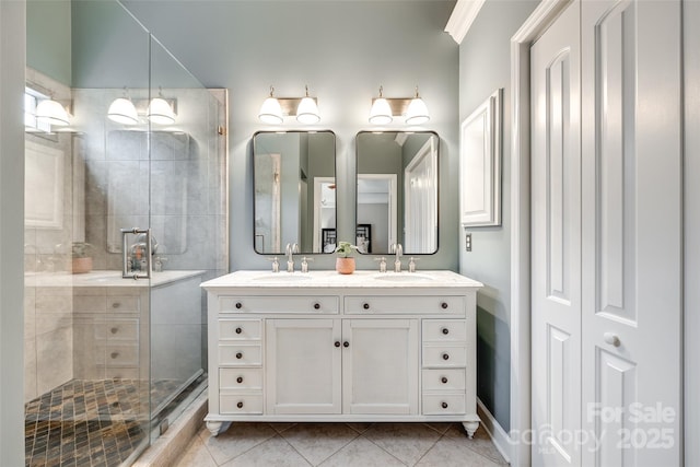 bathroom featuring vanity, a shower with shower door, and tile patterned flooring