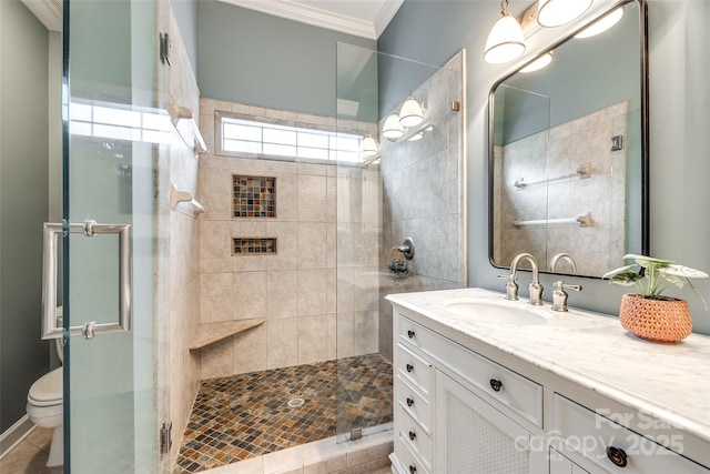 bathroom featuring crown molding, vanity, toilet, and an enclosed shower