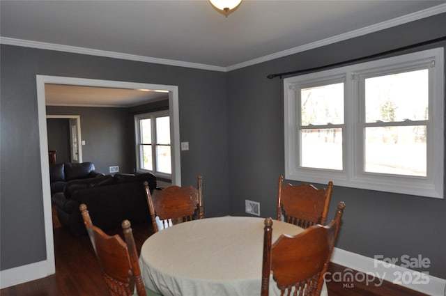 dining space featuring ornamental molding, plenty of natural light, and dark wood-type flooring