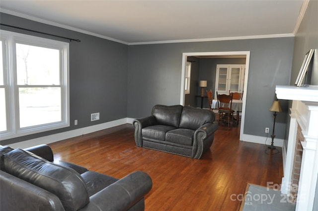 living room with a fireplace, dark hardwood / wood-style floors, and ornamental molding