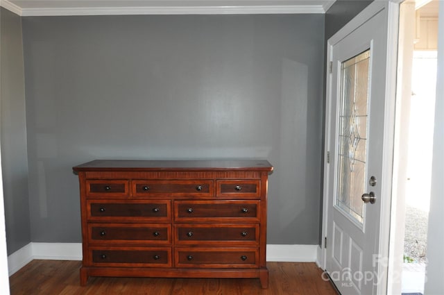 entrance foyer with crown molding and dark wood-type flooring