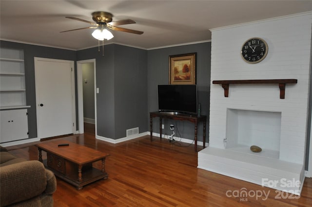 living room with wood-type flooring, ceiling fan, and ornamental molding