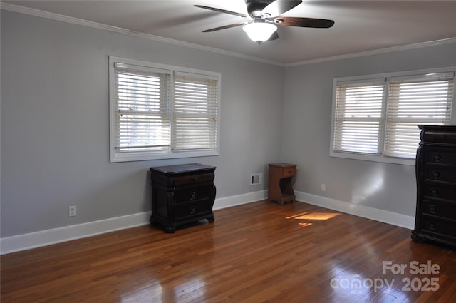 unfurnished bedroom with ceiling fan, dark hardwood / wood-style floors, and crown molding