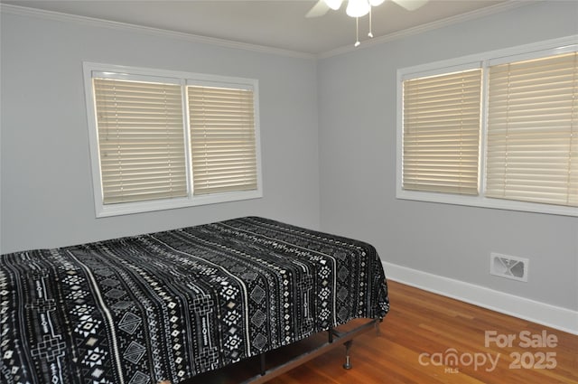 bedroom featuring ceiling fan, hardwood / wood-style flooring, and ornamental molding