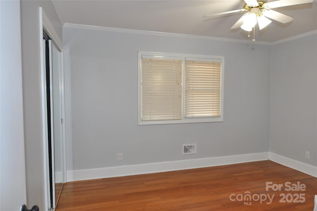 unfurnished bedroom featuring ceiling fan, wood-type flooring, and ornamental molding