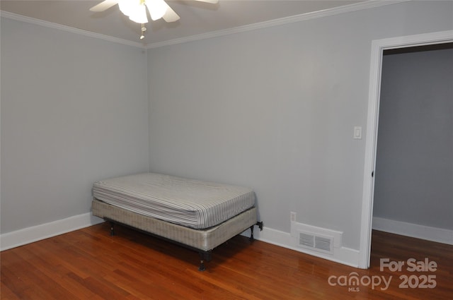 bedroom featuring hardwood / wood-style floors, ceiling fan, and crown molding