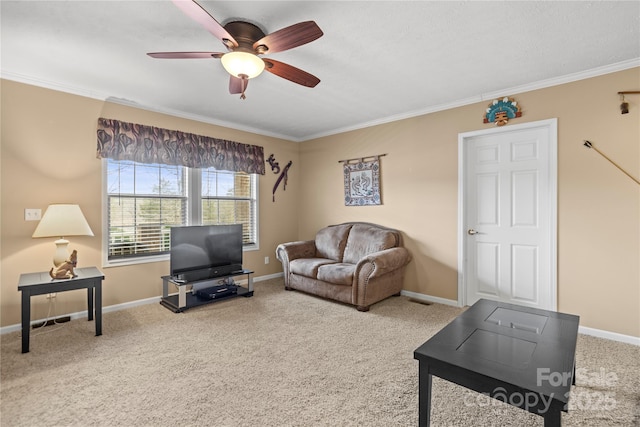 living room featuring ornamental molding, ceiling fan, and carpet flooring