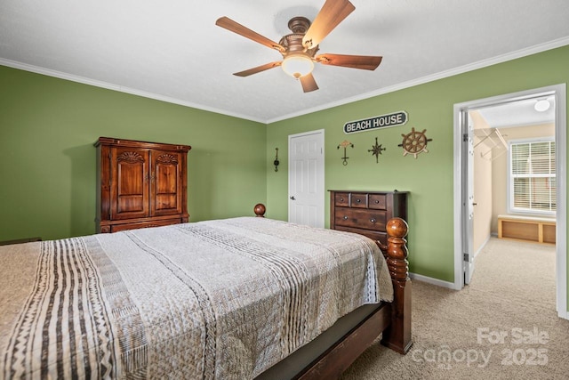 carpeted bedroom with ornamental molding and ceiling fan