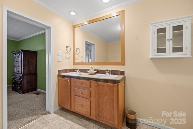 bathroom featuring crown molding, vanity, tile patterned flooring, and a textured ceiling