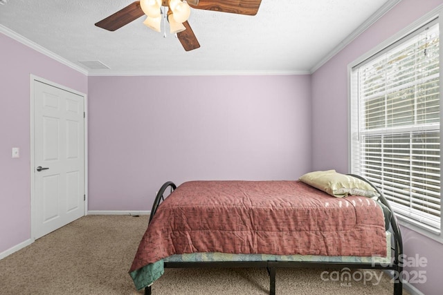 bedroom with crown molding, ceiling fan, and carpet