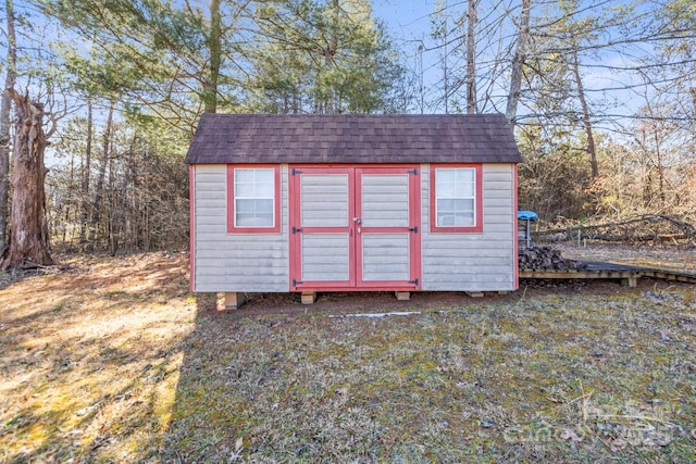 view of outbuilding with a lawn