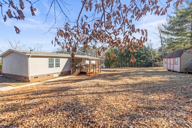 back of property with a storage unit