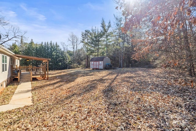 view of yard with a storage unit and a deck