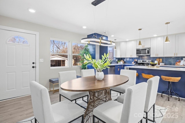 dining space featuring light wood-type flooring