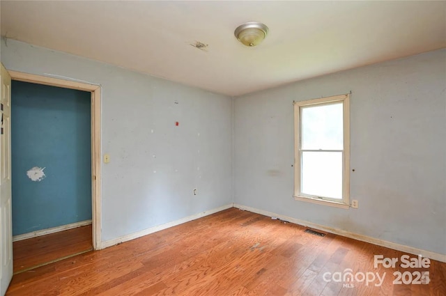 unfurnished room featuring light hardwood / wood-style floors